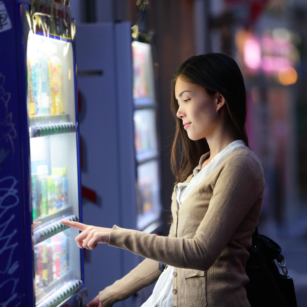 girl using a vending machine