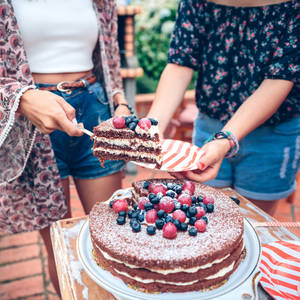 Layered berry cake being served 